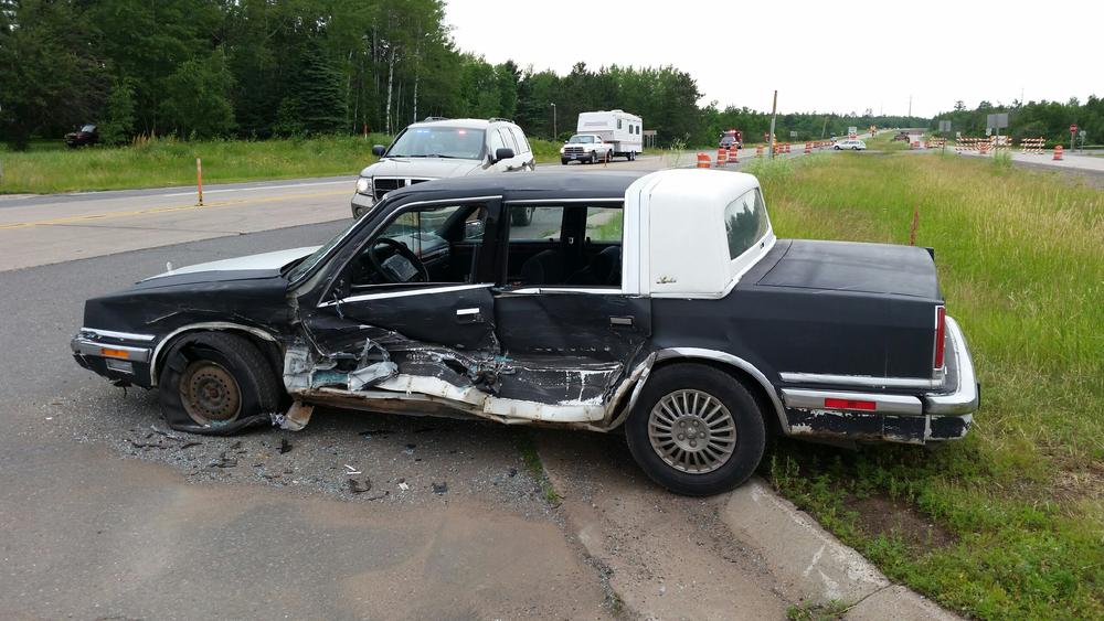 side-view of vehicle with driver's side smashed in from accident